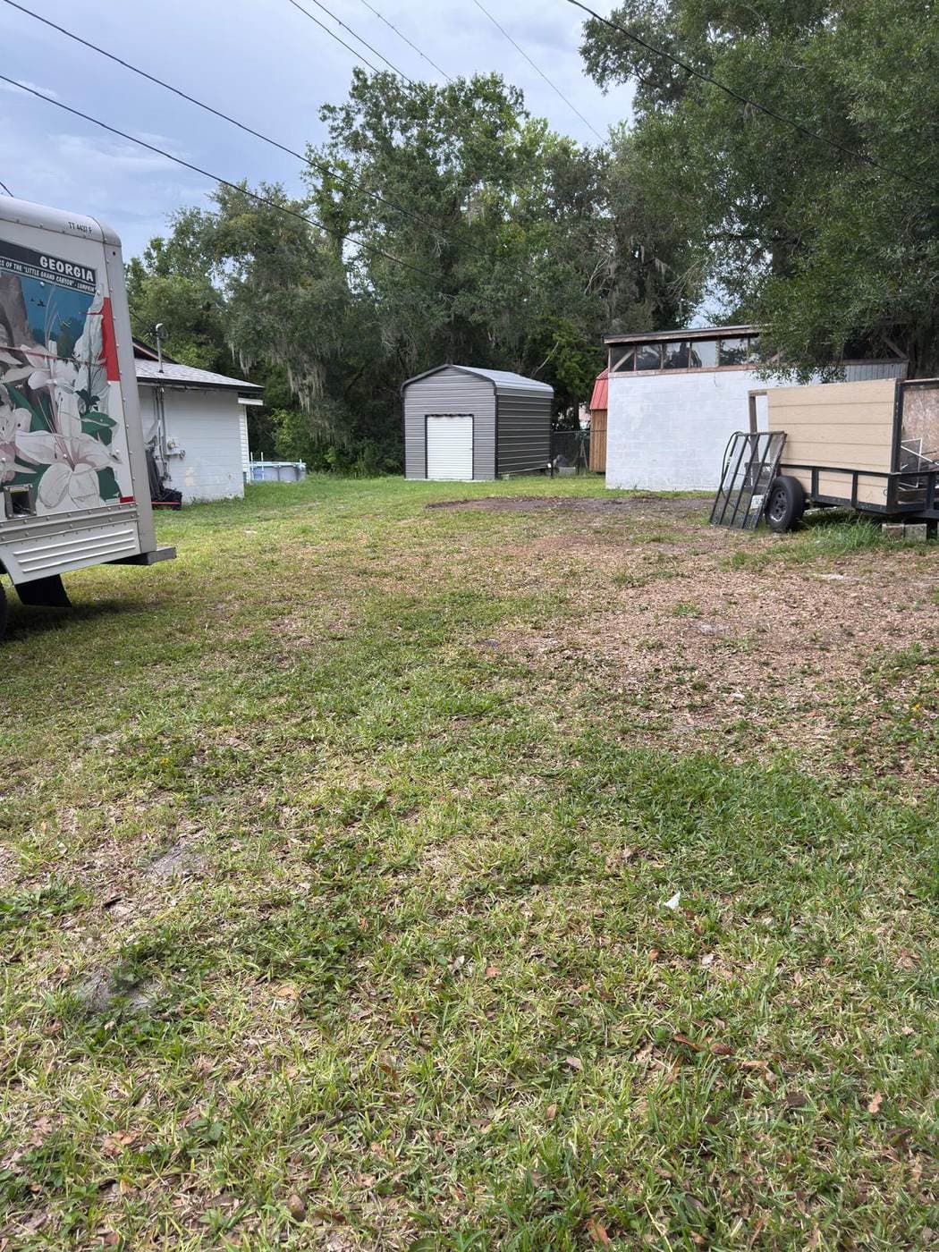 Wide clear yard with JCE trailer on site after cleanout